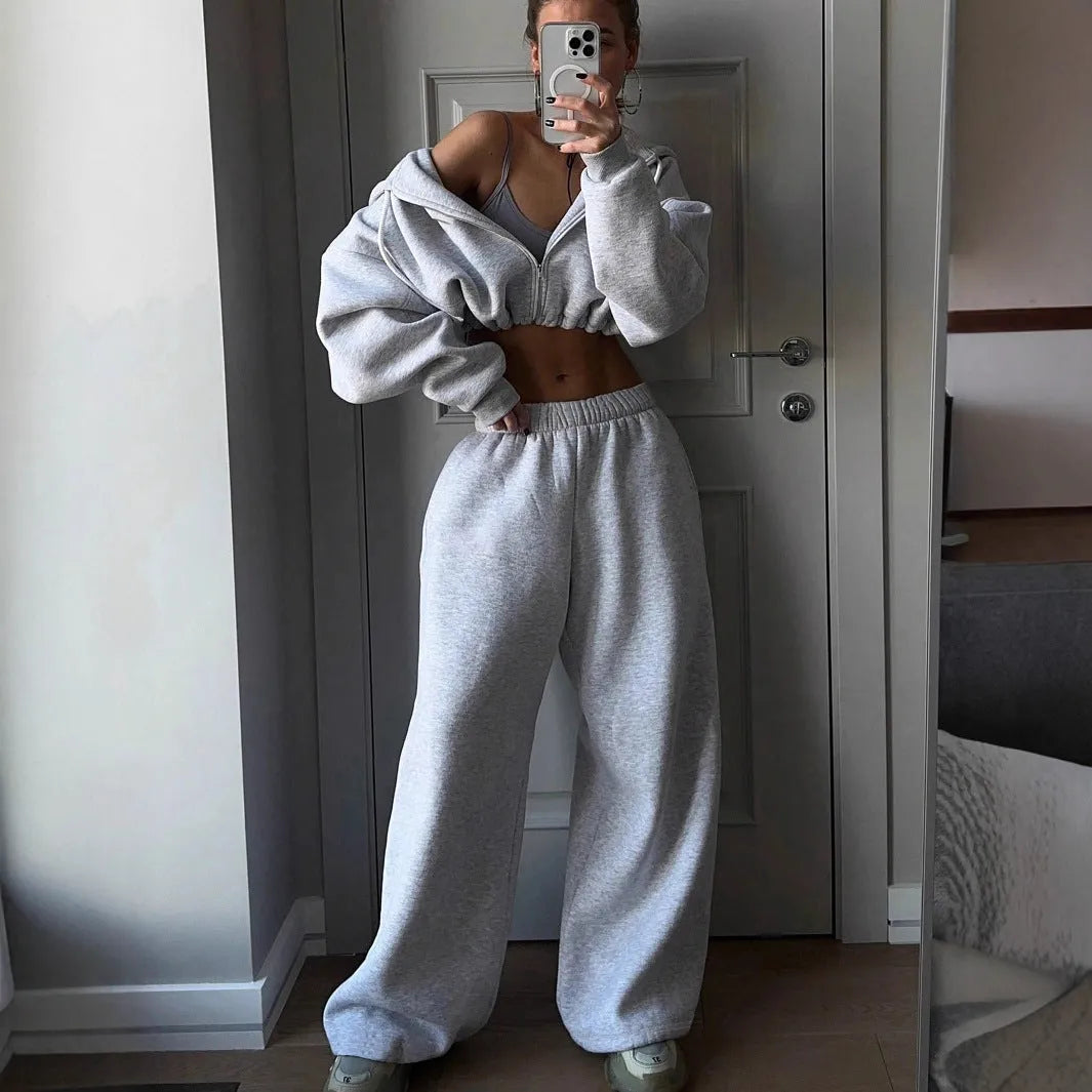 Men's long sleeve grey polyester zip jacket and matching trousers sportswear set laid flat