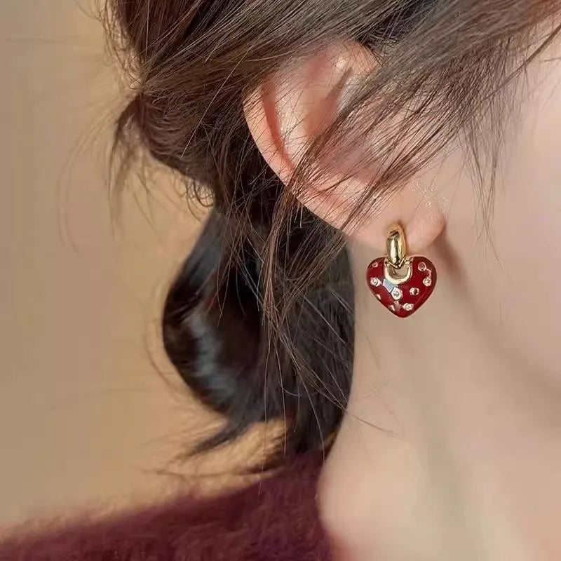 Pair of red heart-shaped ear studs in zinc alloy with electroplated finish