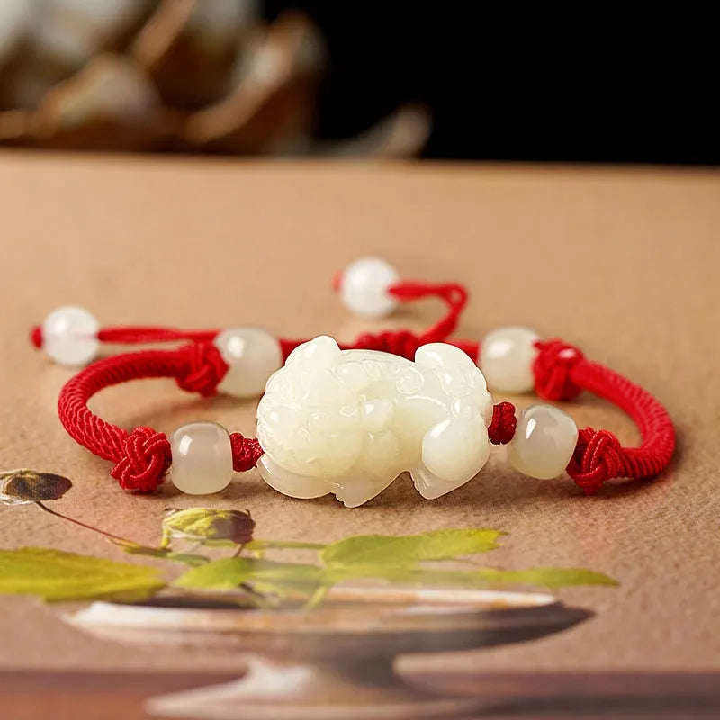 Traditional Chinese Hetian jade bracelet with black and red braided ropes and jade beads on elastic cord