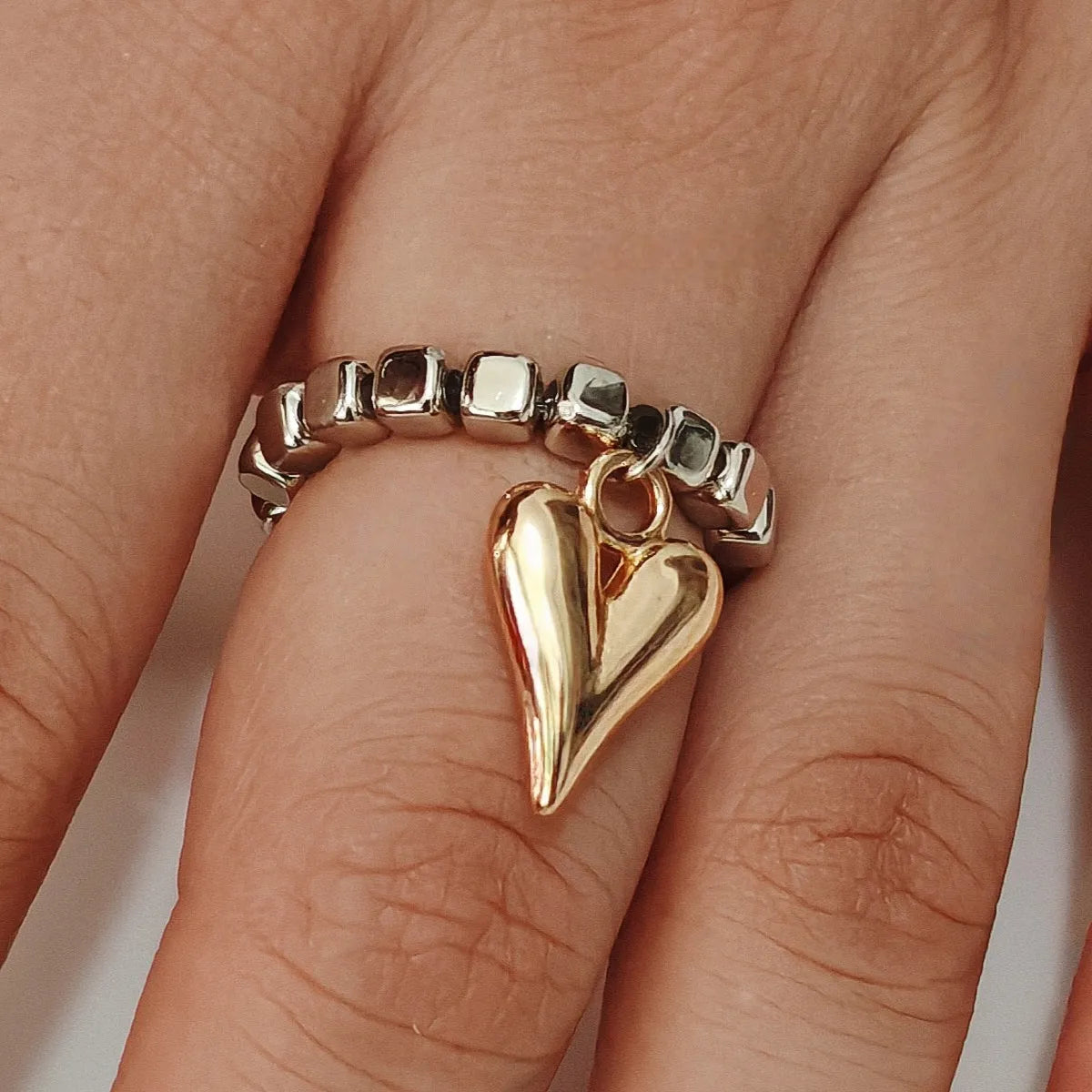 Handmade beaded elastic string love ring with geometric heart design in gold and white colour options