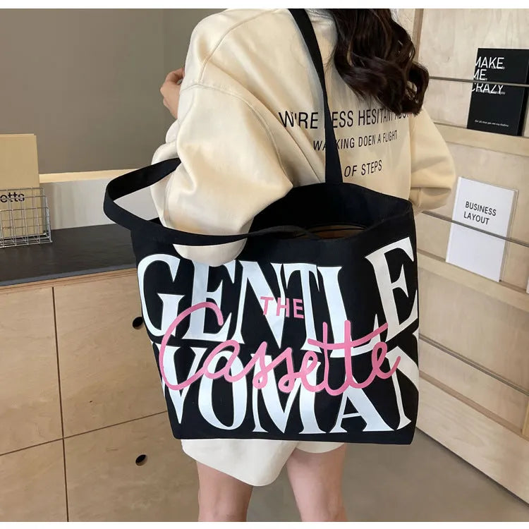 Letter printed canvas tote bag in off white with car stitching detail and top handles