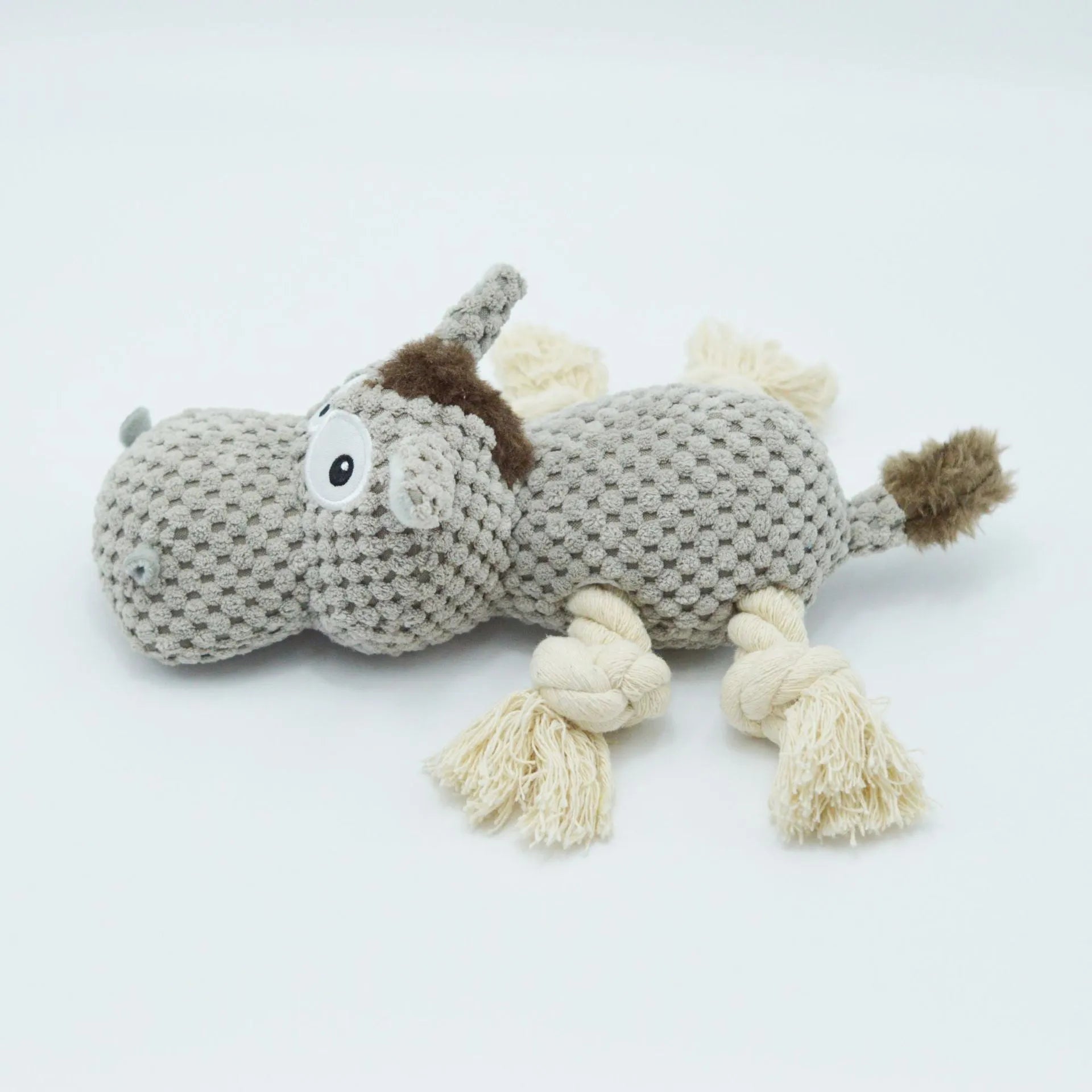 Grey plush donkey dog toy with creaking sound, showing size against a hand.