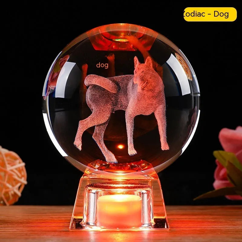White crystal ball zodiac ornament with luminous electronic base showing Chinese animal designs