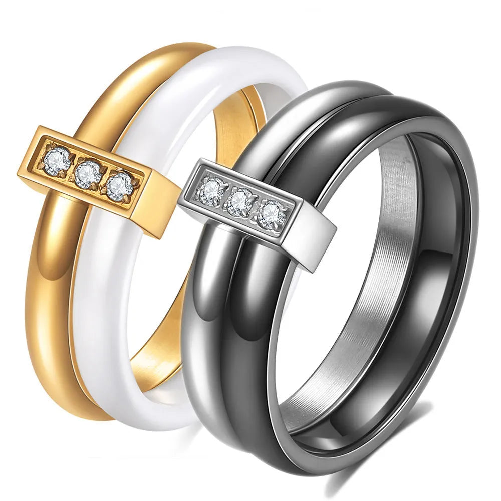 Glossy black ceramic women's ring with silver stitch-inlaid zirconium detail on a geometric band.