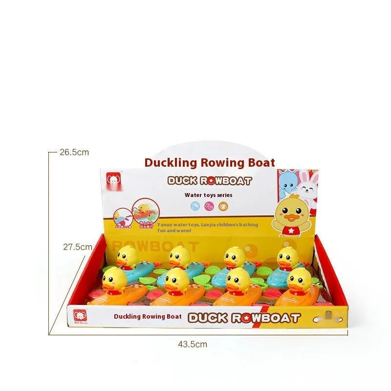 Yellow plastic wind-up duck bath toy swimming in water.