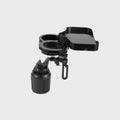 Black car cup holder with wireless charging pad and USB outlet, placed on a vehicle instrument panel.