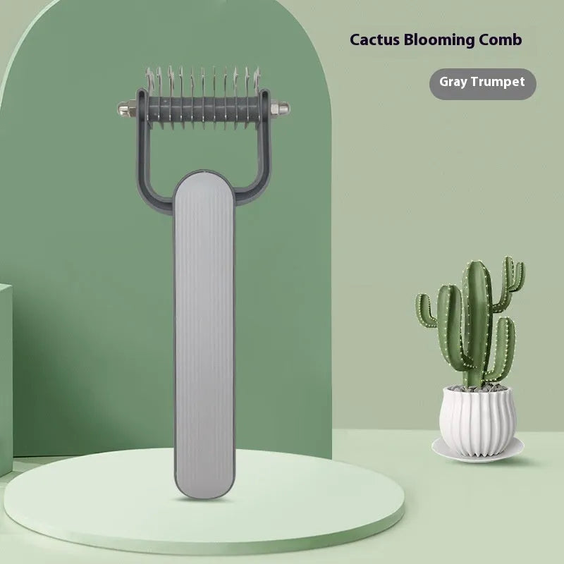 Green plastic and stainless steel dog detangling comb on a grey background.
