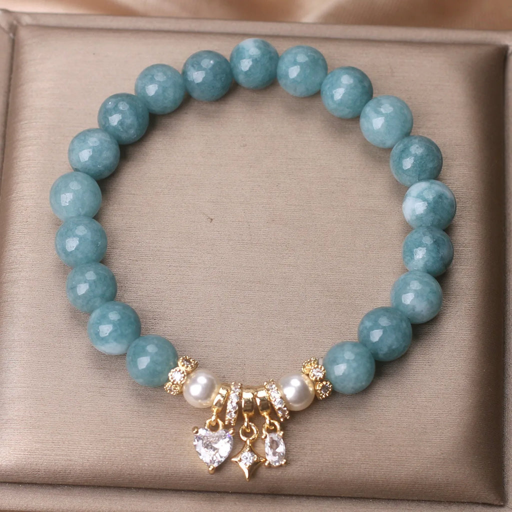 Blue water jade bracelet with heart-shaped zircon pendant and agate beads on display