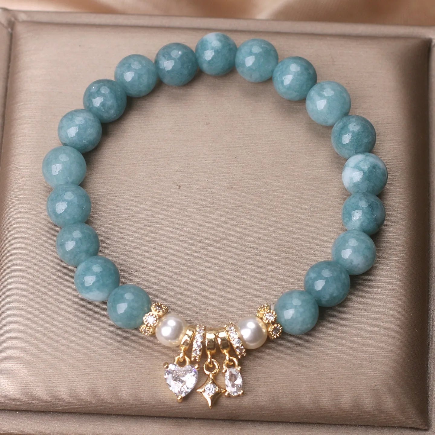 Blue water jade bracelet with heart-shaped zircon pendant and agate beads on display