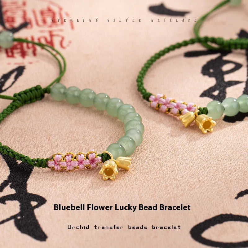 Hand woven red rope bracelet with floral decorative elements in national style design