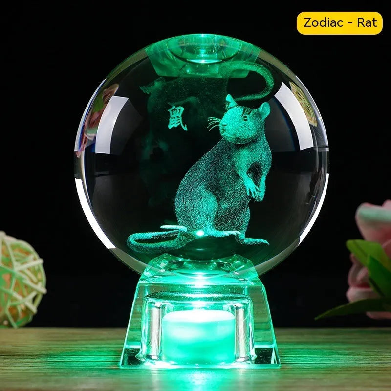 White crystal ball zodiac ornament with luminous electronic base showing Chinese animal designs