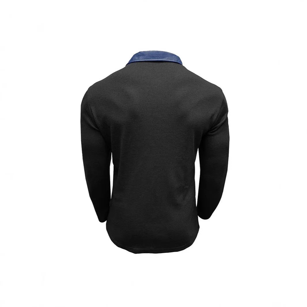 Man wearing a dark green waffle-knit long-sleeved polo shirt with an asymmetric design detail.
