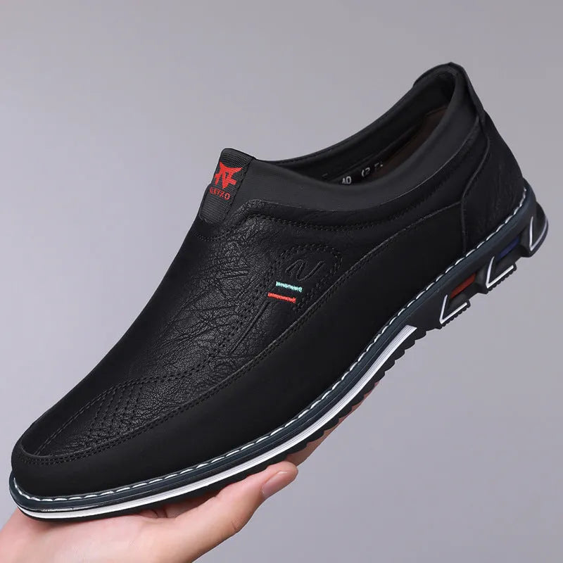 Men's black leather slip-on loafer shoe with a rubber sole and visible stitching detail