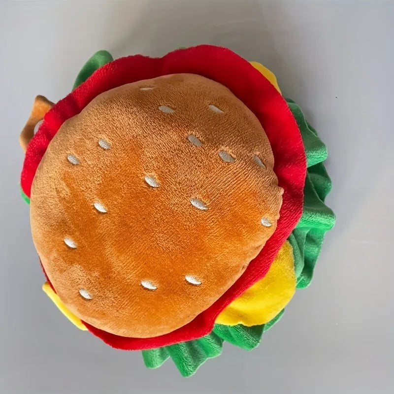 Burger-shaped cartoon headdress collar for a cat, shown on a feline model, with adjustable neck strap.
