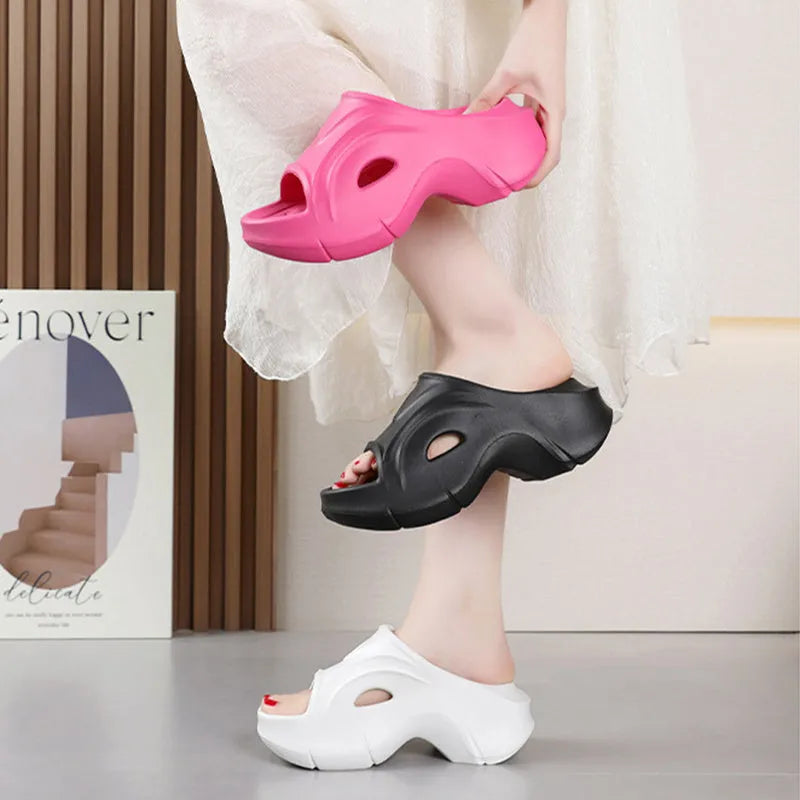 Women's thick-soled EVA slipper in rose red colour on a sandy beach background.