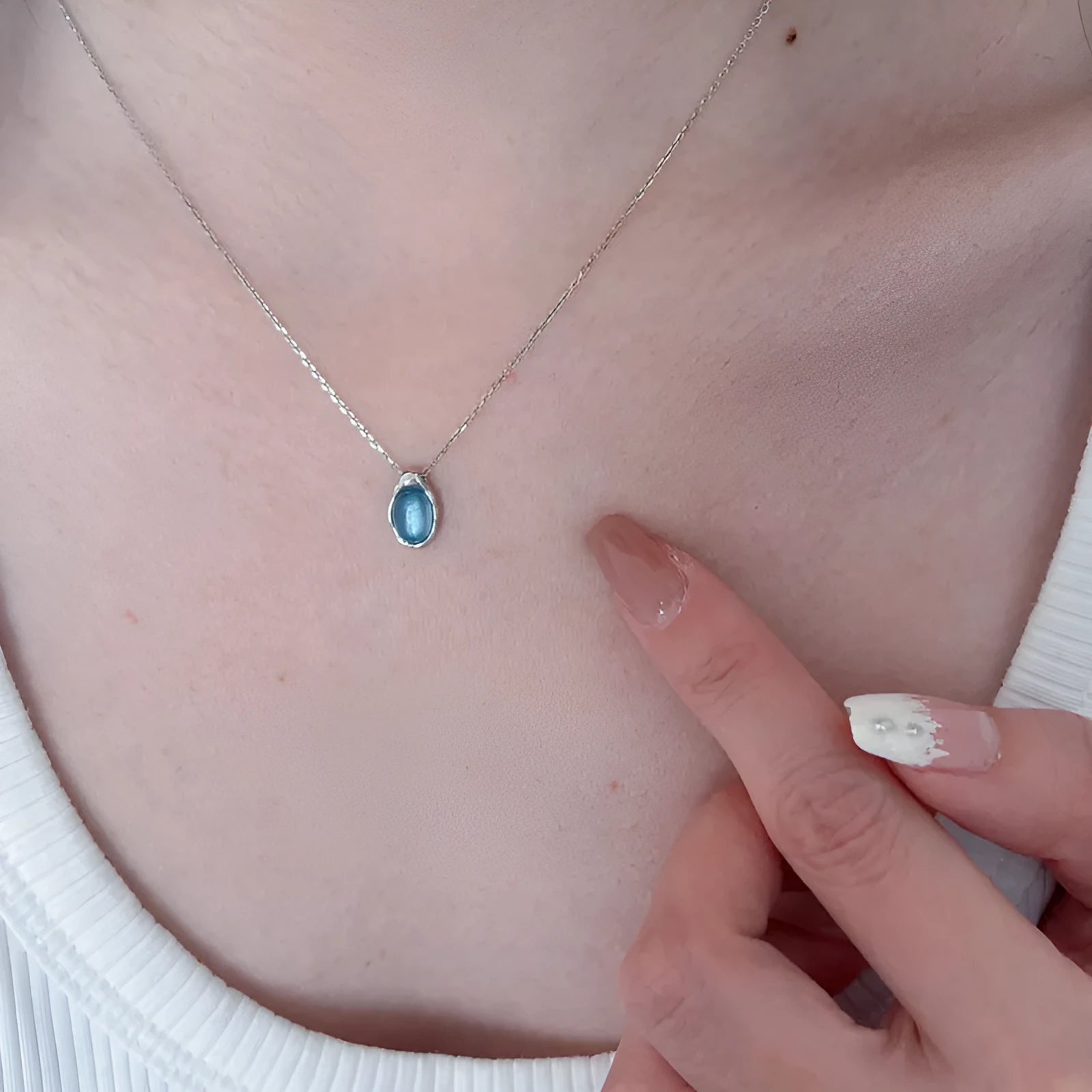 Women's navy blue geometric water drop pendant necklace on an adjustable copper chain.