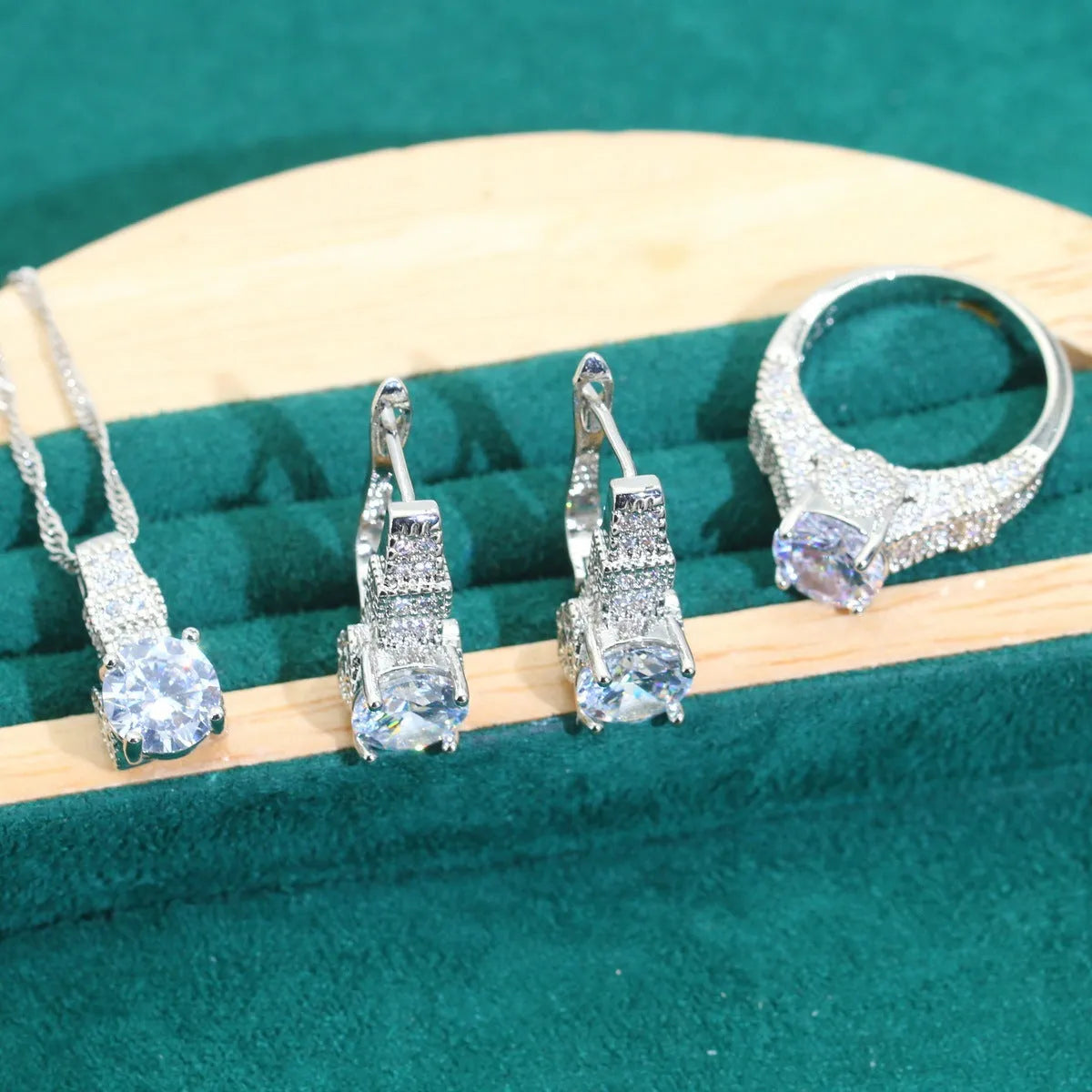 Bridal zircon alloy jewellery four-piece set showing necklace, earrings, ring and bracelet on water wave chain