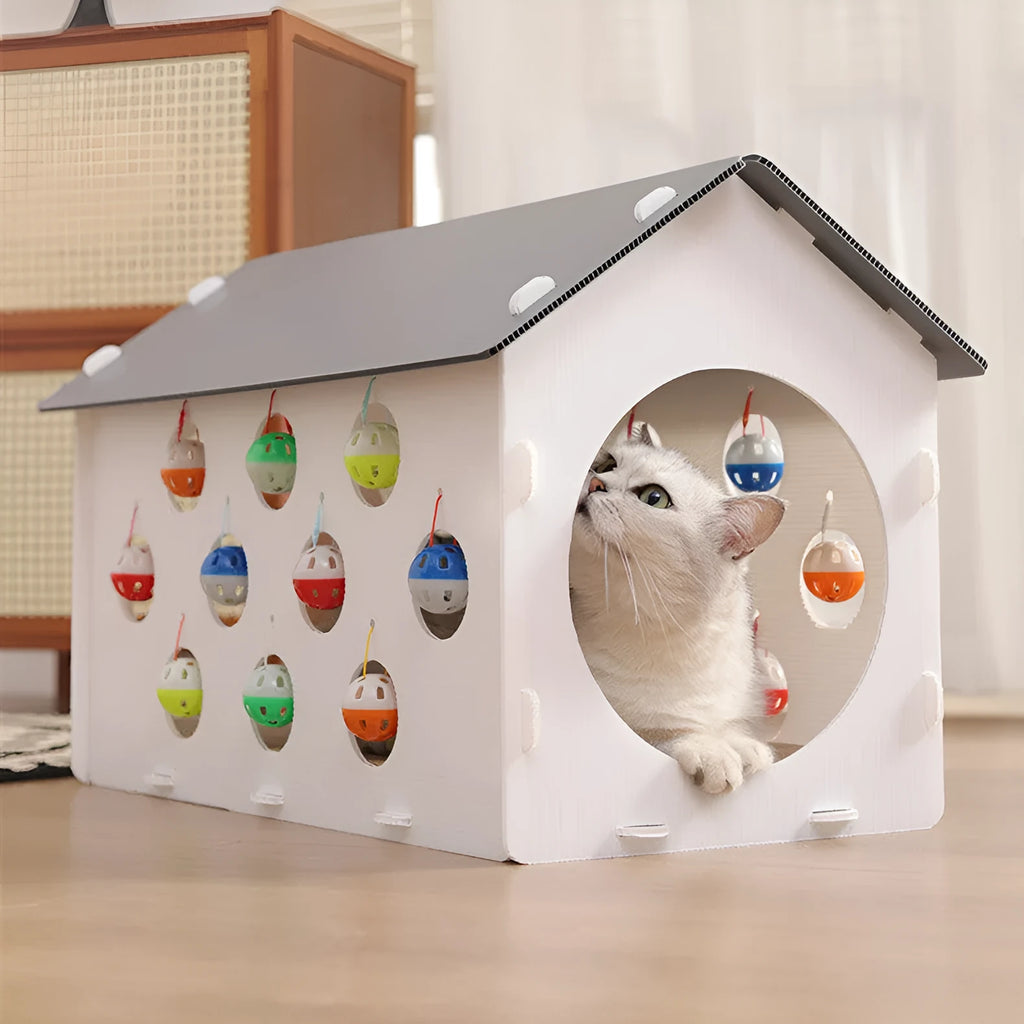 White plastic integrated cat scratch board with attached enclosed nest and curving tunnel toy for indoor cats.