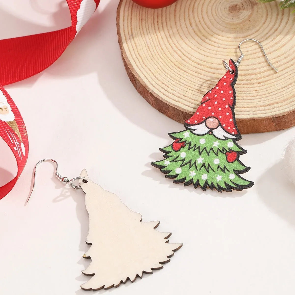 Wooden Christmas earrings with printed tree and snowman designs on geometric shapes