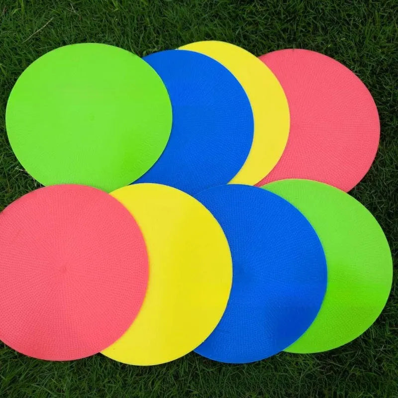 23cm diameter football training landmark pad in bright colours on grass field