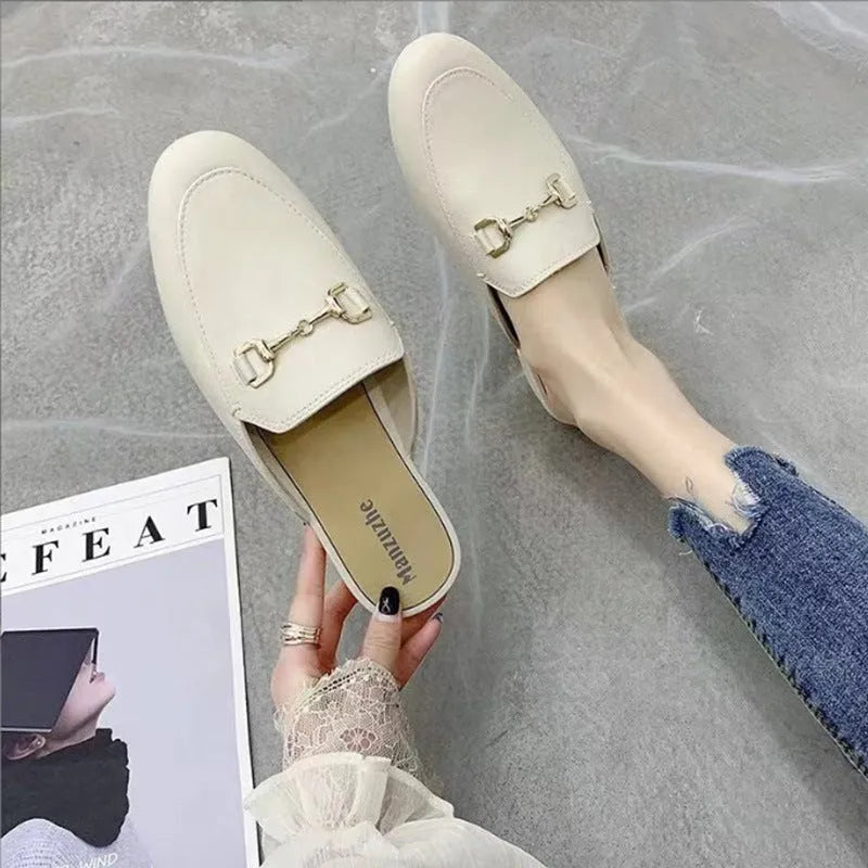 Women's PVC closed toe half slipper with metal buckle fastening in milky white.