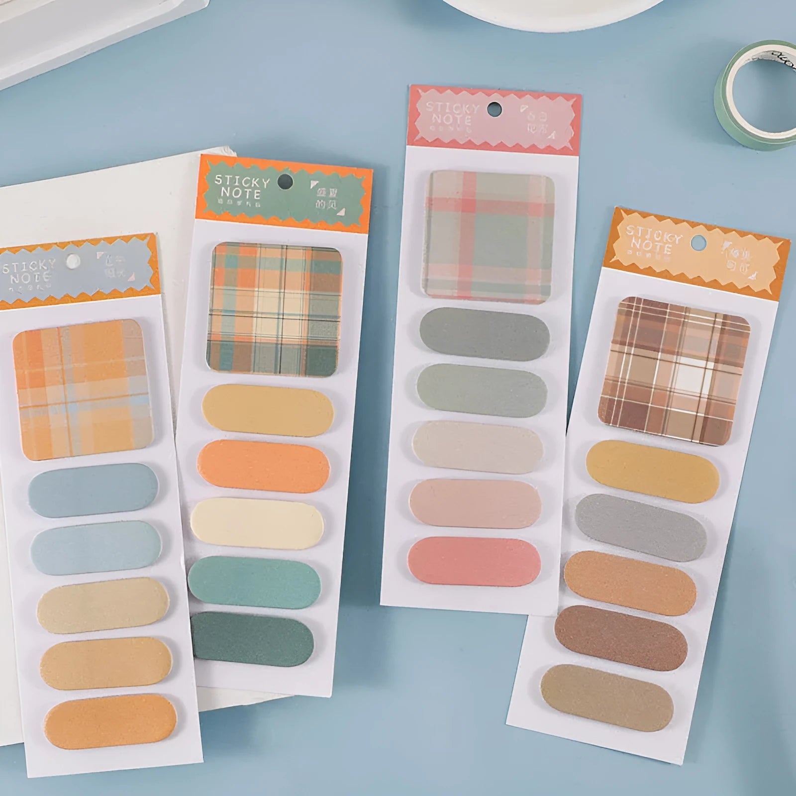 Set of colourful sticky note memo pads in eight designs including plaid and solid colours.