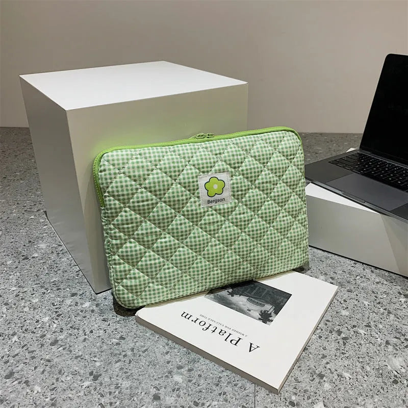 South Korean Ins cotton tablet handbag in green flower pattern with zipper closure on a table