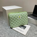 South Korean Ins cotton tablet handbag in green flower pattern with zipper closure on a table
