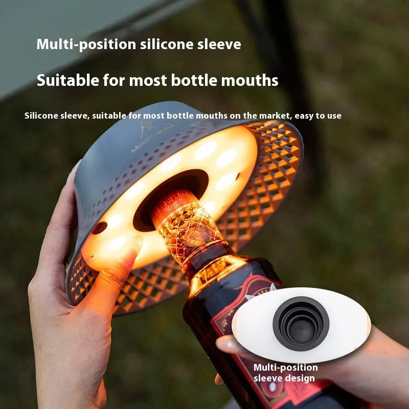 Beige wine bottle-shaped camping lantern with USB-C port and three light mode gear.