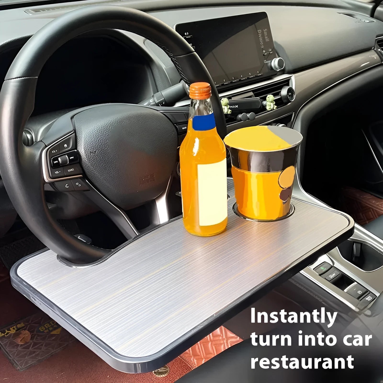 Black ABS plastic car steering wheel laptop stand with foldable design on vehicle dashboard