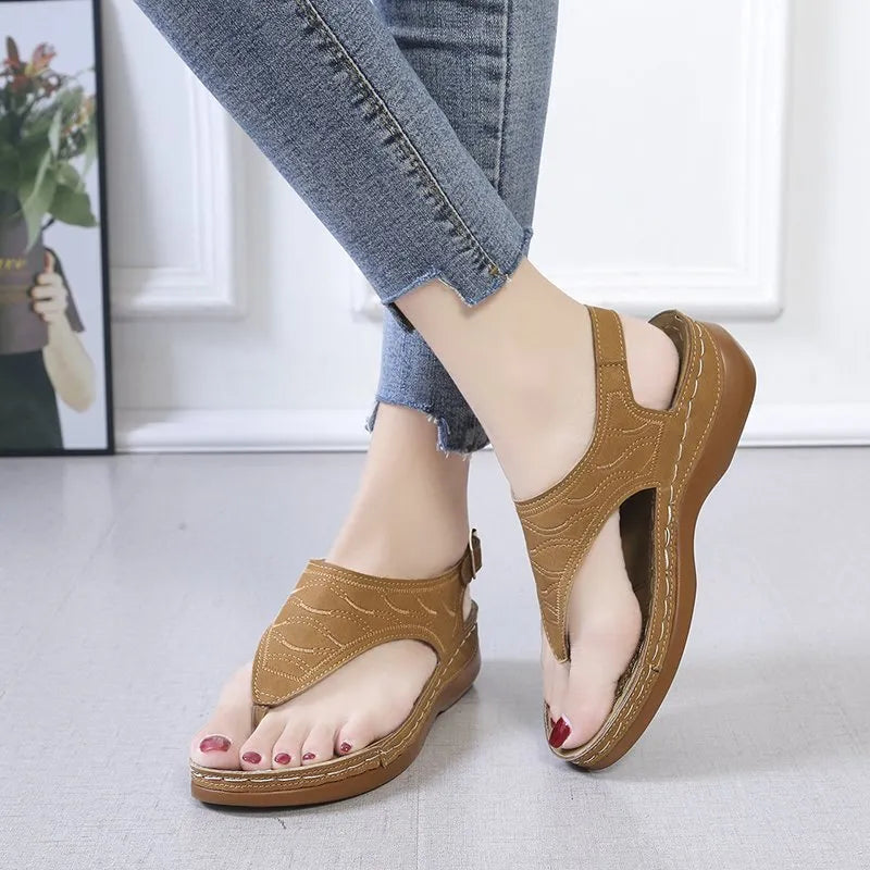 Women's solid colour wedge heel flip flop sandals with an adjustable buckle strap.