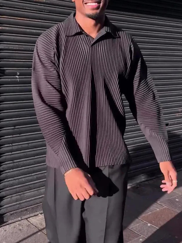 Men's black long-sleeved casual top with pleated detail, made from polyester fabric.