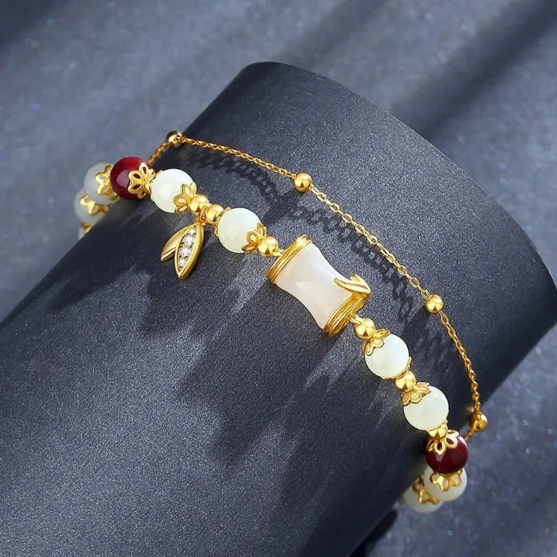 Retro style bamboo bracelet with coloured glass floral beads and ruyi design