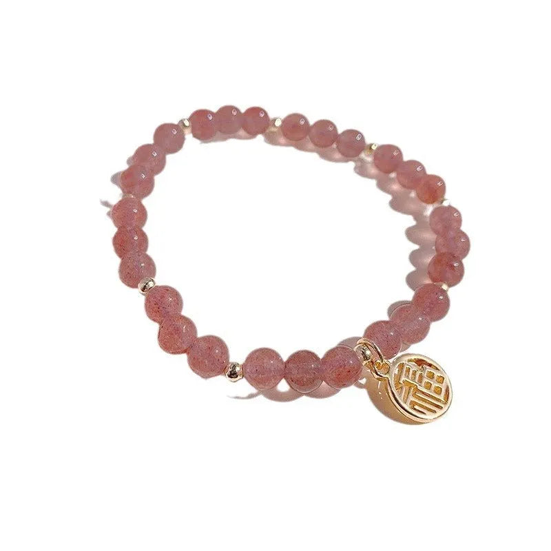 A New Chinese style glass bracelet with strawberry quartz stones and a blessing card.