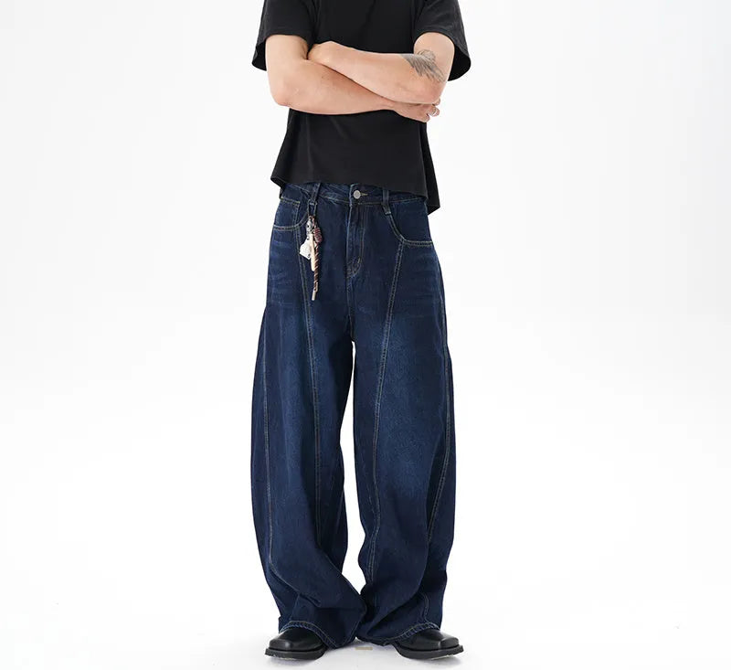 Dark blue washed distressed wide leg machete jeans on a model, showing the denim fabric and relaxed fit.