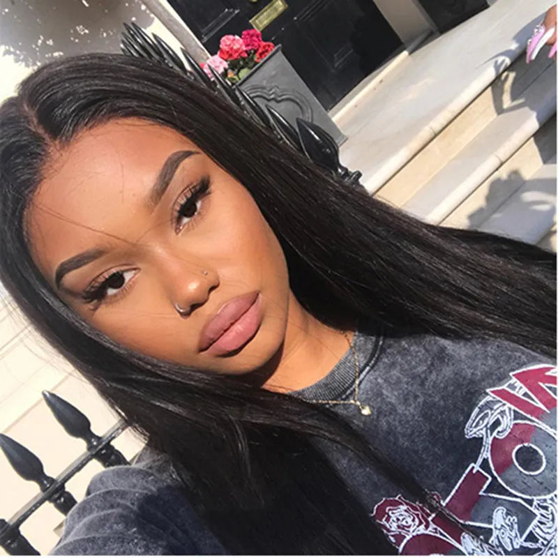 Long straight black synthetic wig with centre-parted bangs on display
