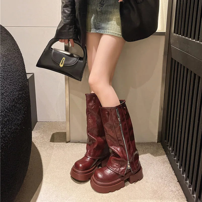 Black platform muffin pants Martin boots with a high cylinder sock and square heel.