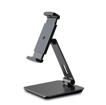 Silver foldable aluminium phone and tablet stand on a desk, holding a tablet at an angle.