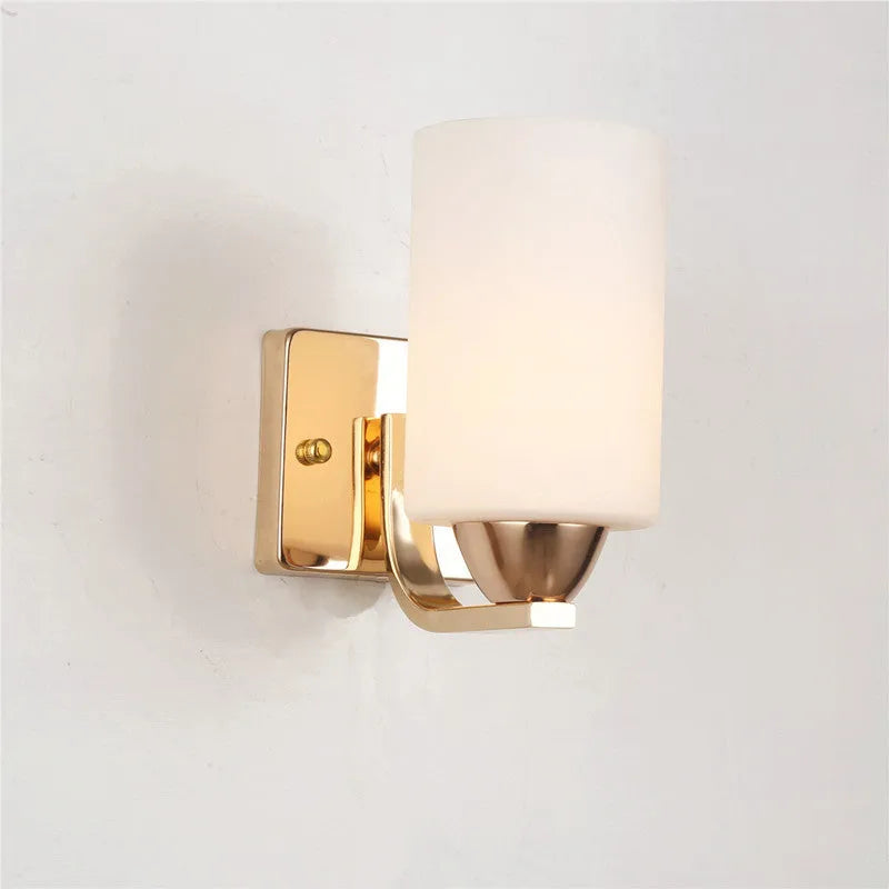 Chrome-finished modern wall lamp with glass shade, shown in single head configuration.