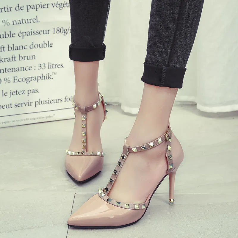 Studded pointed high heels in black with stiletto heel and buckle strap