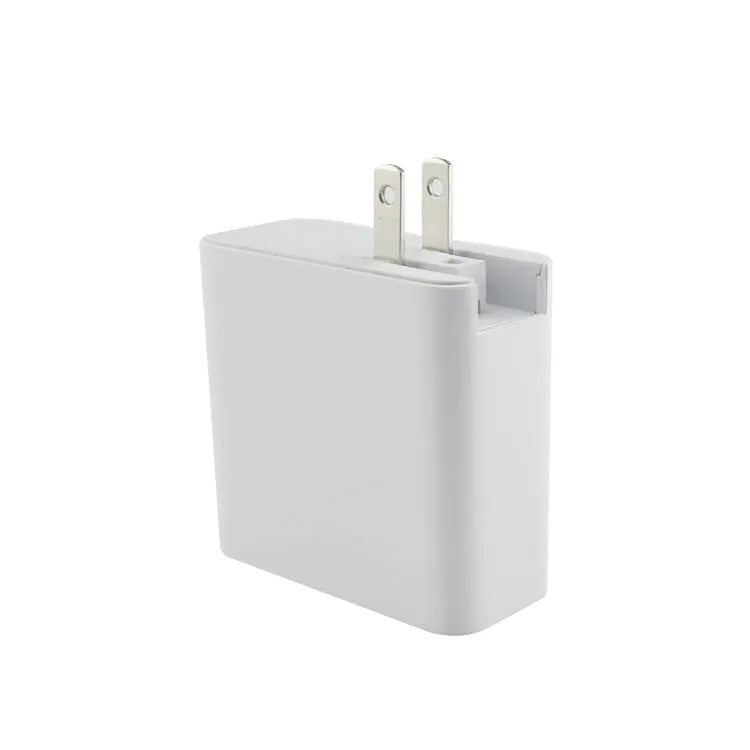 Black and white four-port USB-C wall charger with interchangeable UK, US, EU, and AU plug heads.