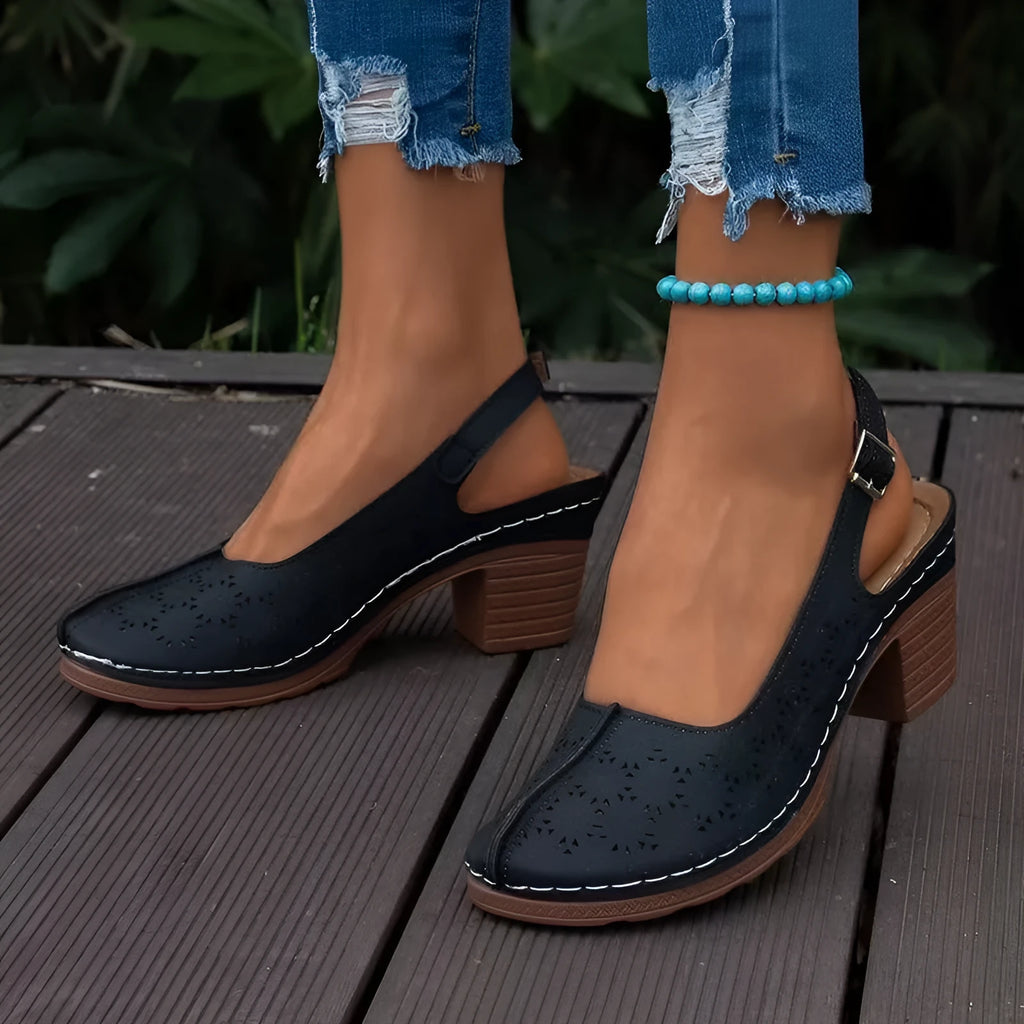 Women's black closed toe wedge sandals with a round toe and rubber sole on a white background.