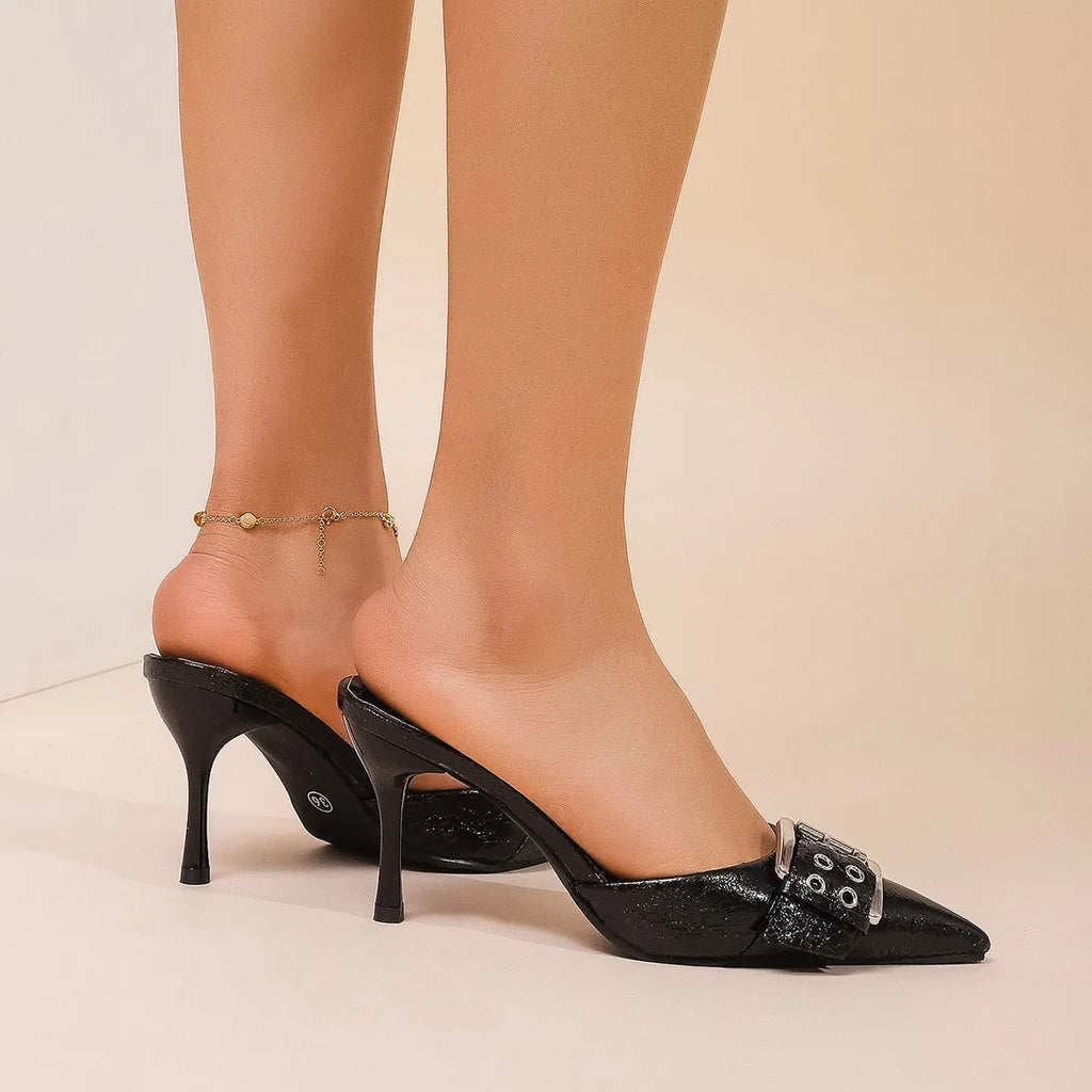 Black women's pointed toe high heels with a strap and buckle closure.