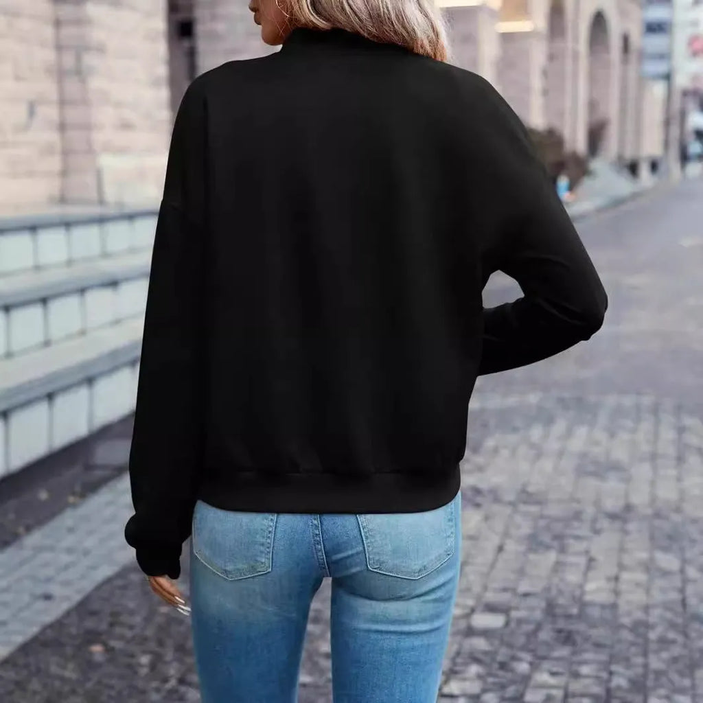 A black women's casual zip-up jacket with long sleeves on a hanger.