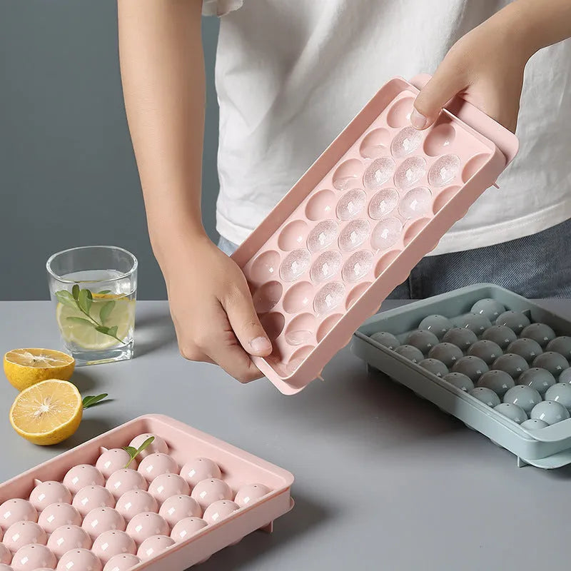 Sky blue or pink plastic ice cube tray making round ball ice for drinks.