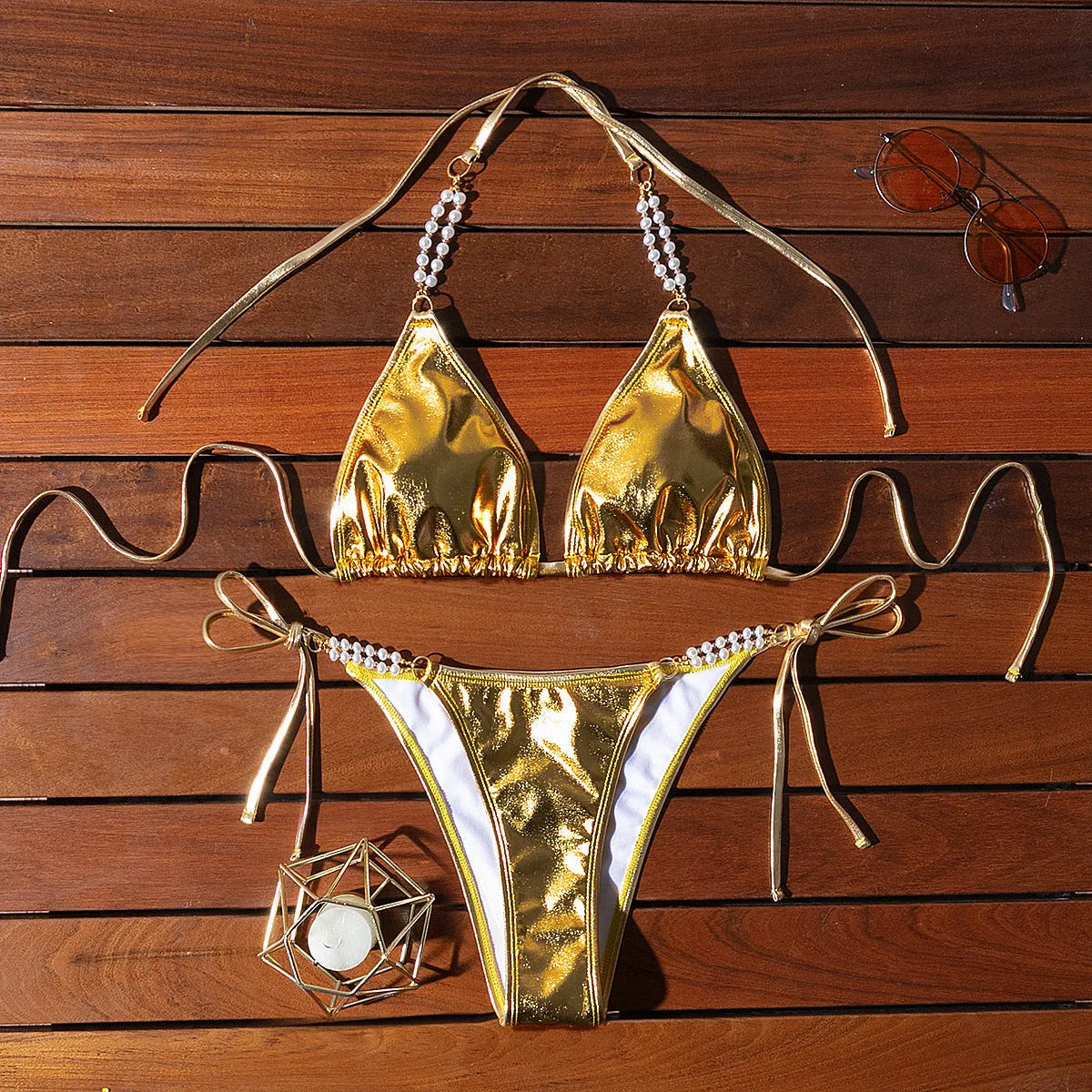 Gold halter lace-up bikini swimsuit with pearl chain detailing on mannequin