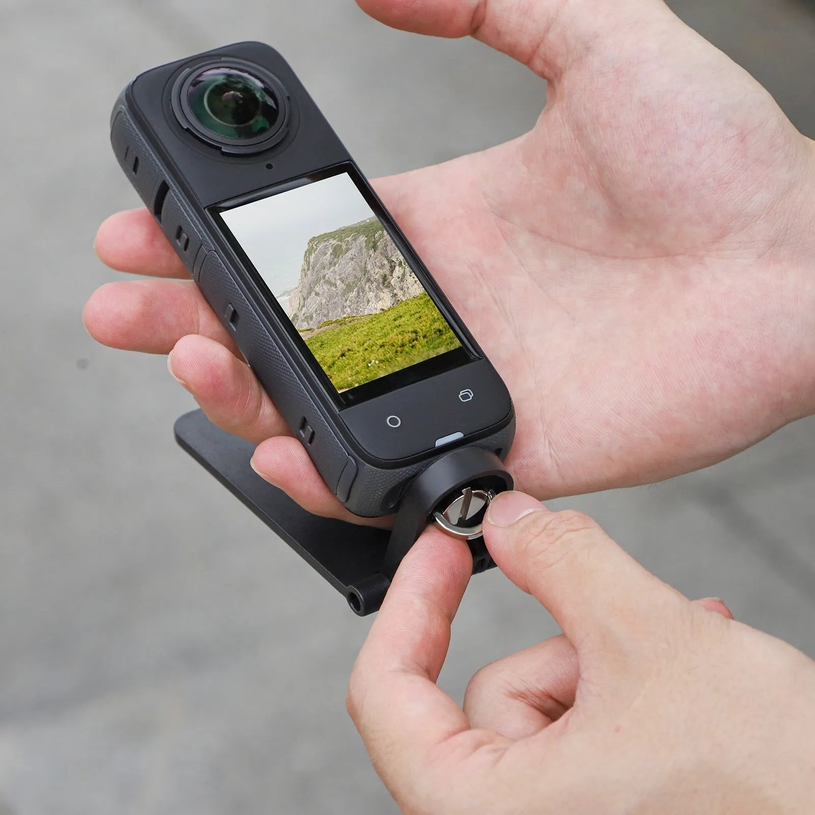 Black Insta360 X4 magnetic bracket base with angle adjustable design and handheld handle