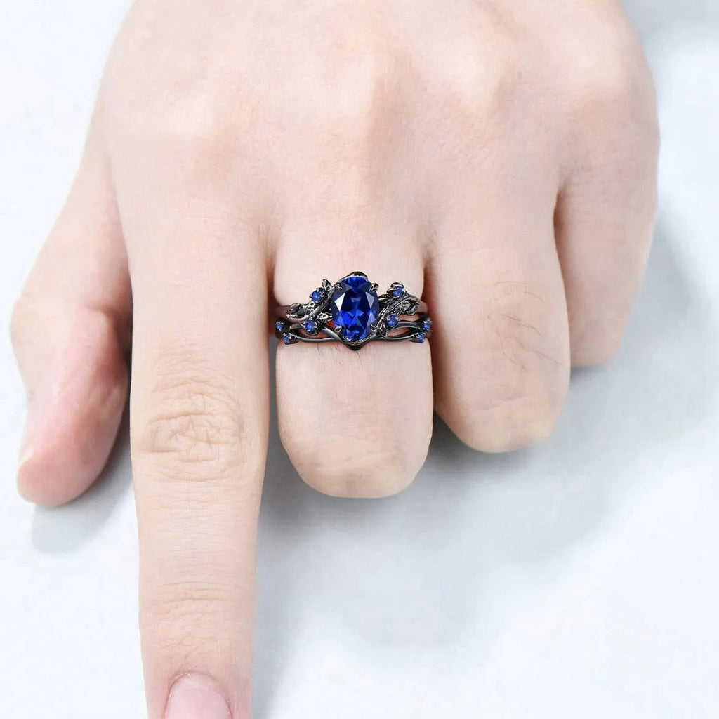 Geometric gun black women's couple ring with a navy blue rhinestone inlay on a copper band.