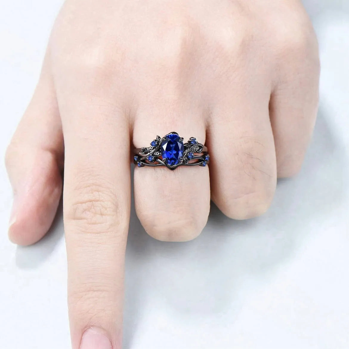 Geometric gun black women's couple ring with a navy blue rhinestone inlay on a copper band.