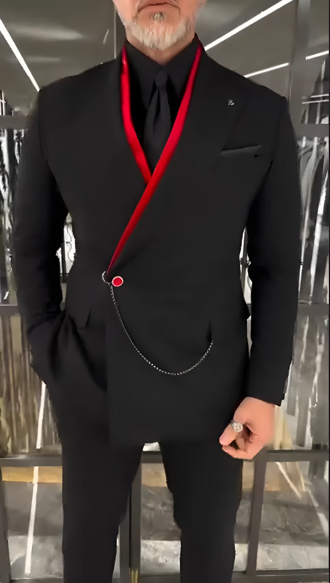 Fake double-layered black jacket with red inside and chain detail worn as streetwear